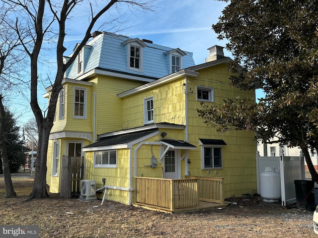 back of house with ac unit