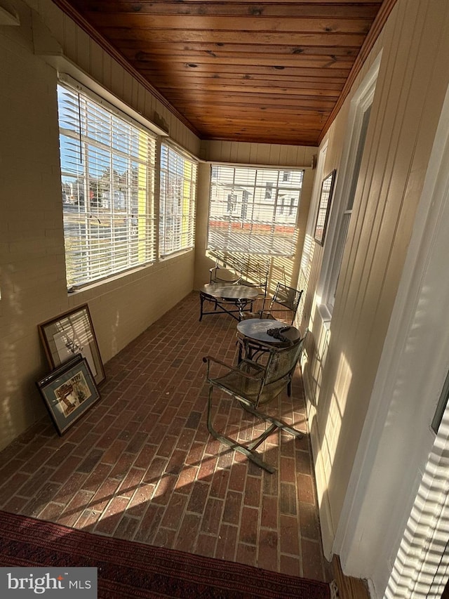 sunroom featuring wooden ceiling