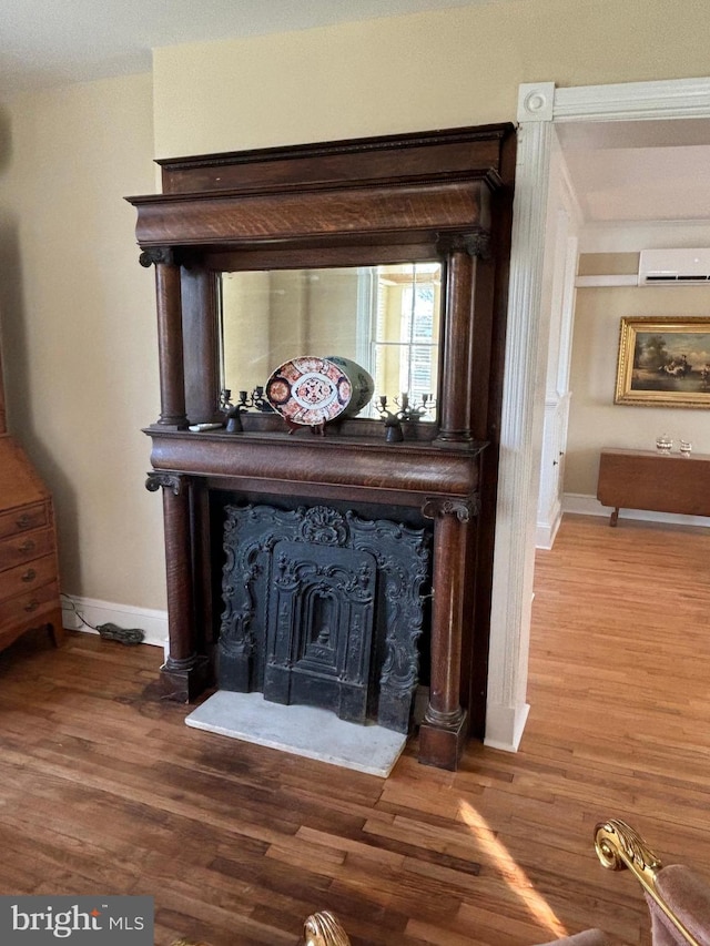 room details featuring hardwood / wood-style floors and an AC wall unit