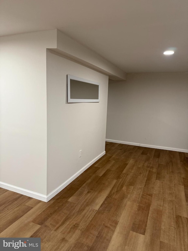 basement with hardwood / wood-style flooring