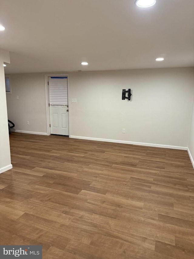 basement with hardwood / wood-style flooring