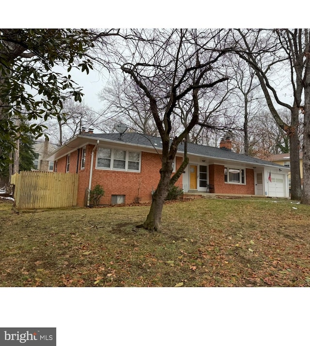 view of front of home featuring a garage and a front yard