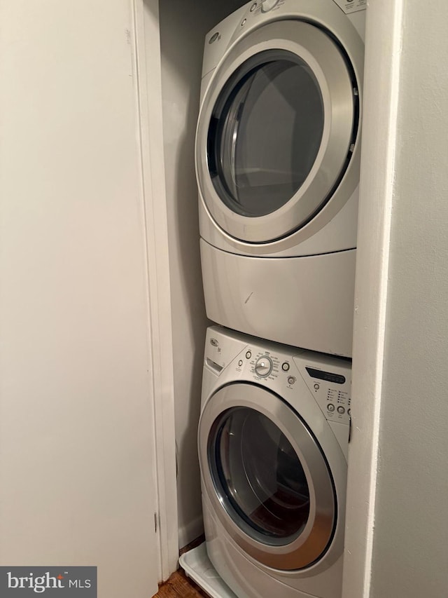 laundry area with stacked washer and clothes dryer