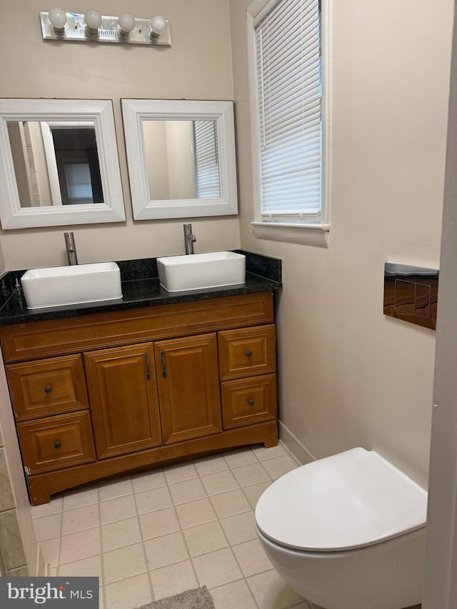 bathroom with vanity, tile patterned floors, and toilet