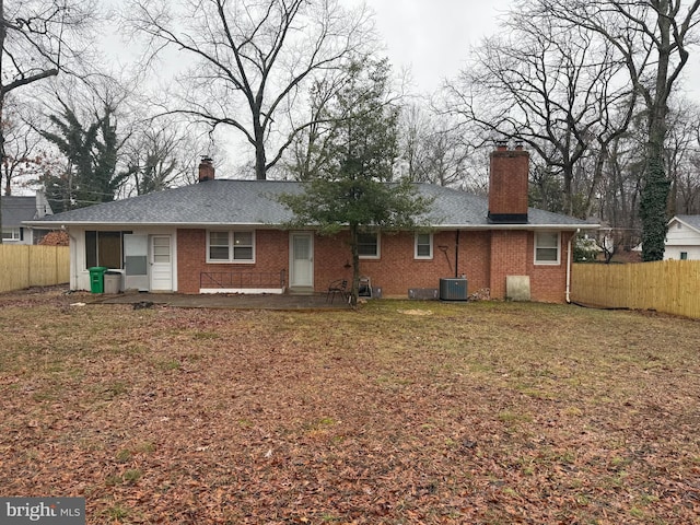 back of house with a patio, central AC unit, and a lawn