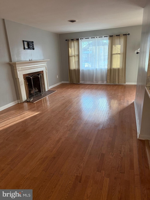 unfurnished living room featuring hardwood / wood-style floors