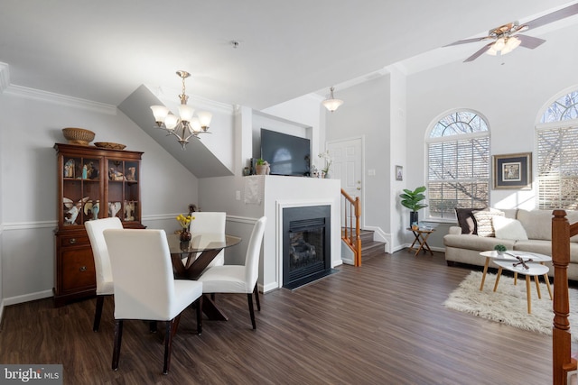 dining room with ceiling fan with notable chandelier, ornamental molding, and dark hardwood / wood-style floors