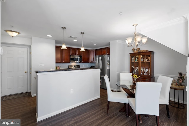 dining space with dark hardwood / wood-style floors and a chandelier