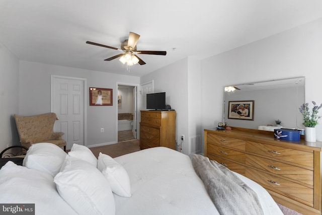 bedroom featuring ceiling fan and ensuite bath