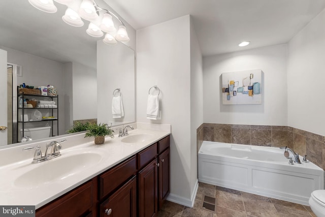 bathroom with a washtub, vanity, and a chandelier