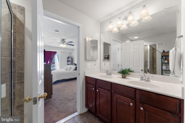 bathroom with tile patterned flooring, vanity, an enclosed shower, and ceiling fan