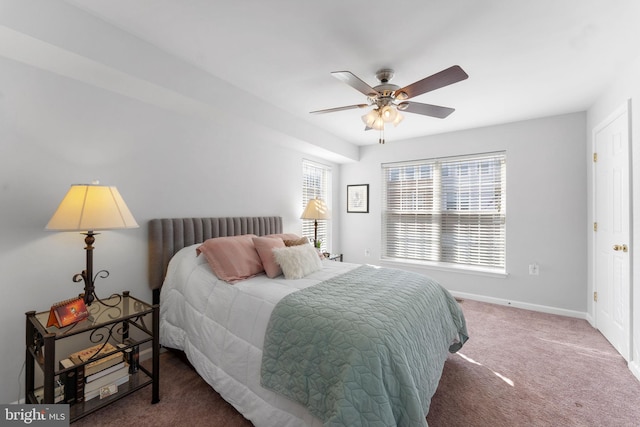 bedroom featuring ceiling fan and dark carpet