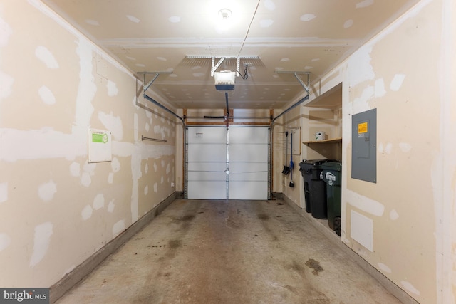 garage with a garage door opener and electric panel