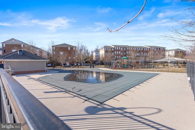 view of swimming pool featuring a playground and a patio area