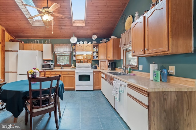 kitchen with white appliances, tile patterned flooring, sink, and wooden ceiling