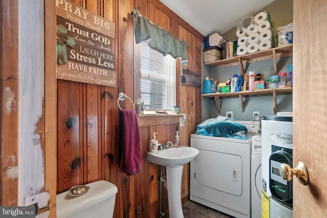 bathroom with washing machine and dryer and toilet