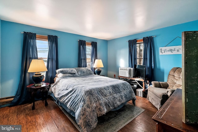 bedroom with dark hardwood / wood-style flooring