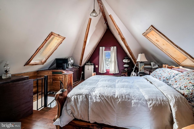 bedroom featuring dark hardwood / wood-style flooring and vaulted ceiling with skylight