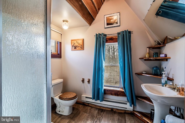 bathroom with hardwood / wood-style flooring, toilet, and a baseboard heating unit