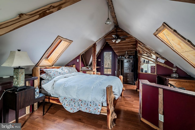 bedroom with vaulted ceiling with skylight and dark hardwood / wood-style flooring