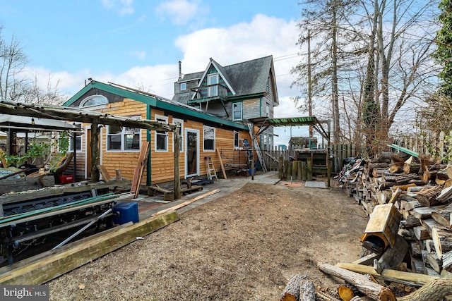 rear view of property featuring a pergola