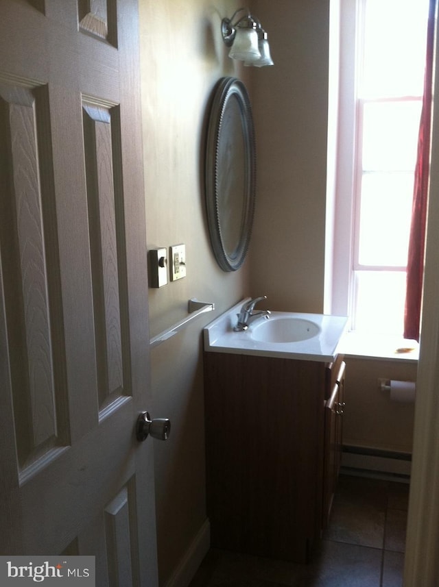 bathroom featuring a baseboard radiator and vanity