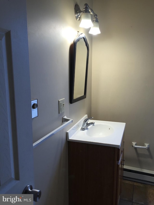 bathroom with tile patterned floors, vanity, and a baseboard heating unit