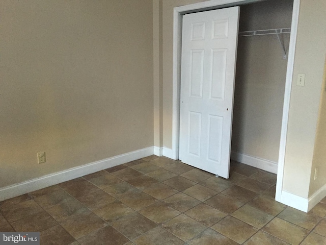 unfurnished bedroom with a closet