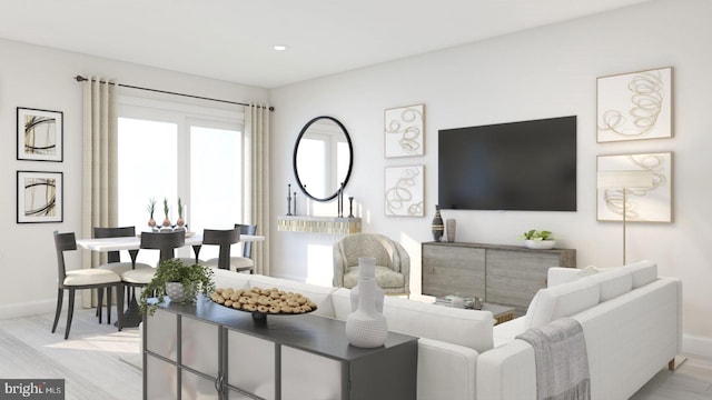 living room featuring recessed lighting, baseboards, and light wood-style floors