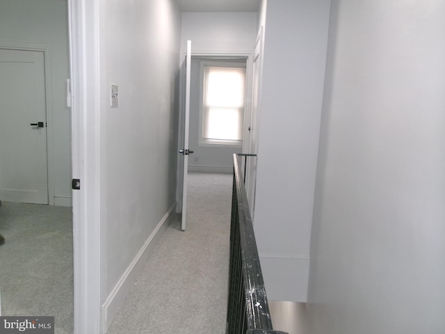 hallway featuring light carpet