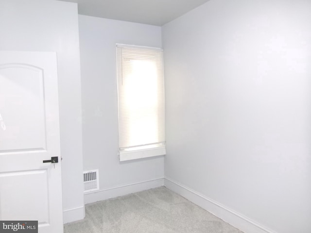 empty room featuring light colored carpet