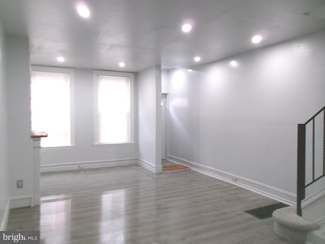 unfurnished room with wood-type flooring