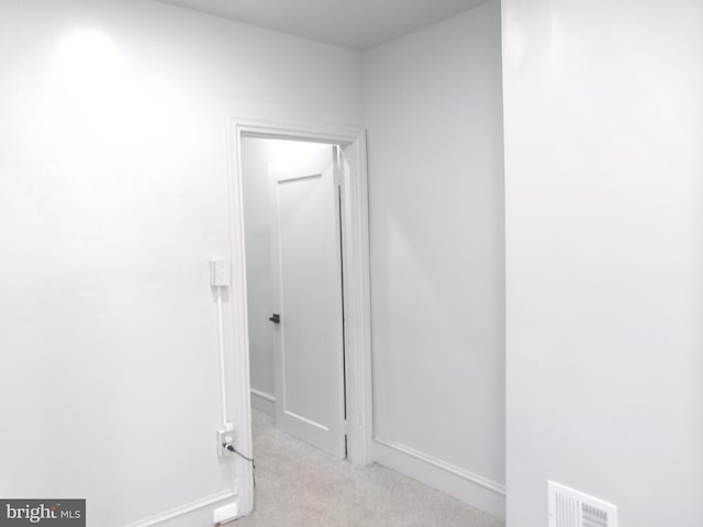 hallway with light colored carpet