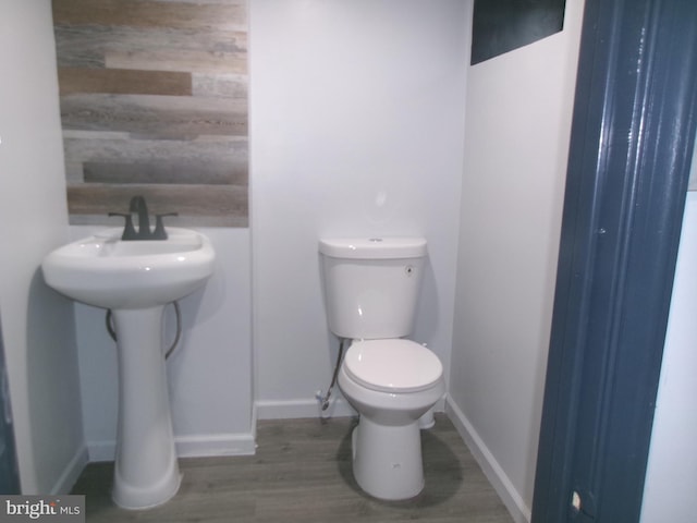 bathroom with wood-type flooring and toilet