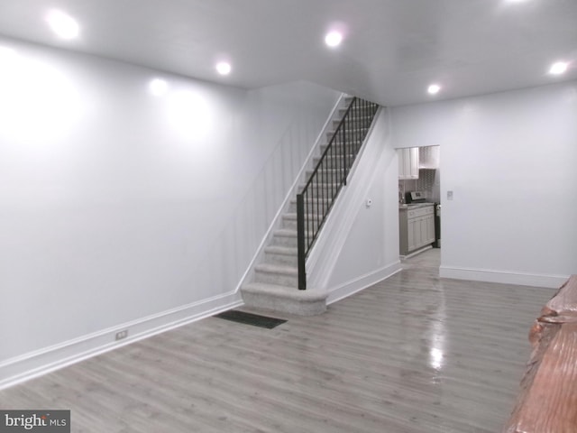 stairway featuring hardwood / wood-style flooring