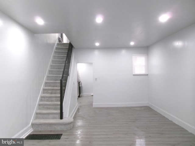 staircase featuring wood-type flooring