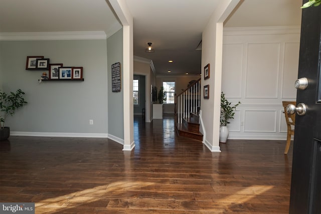 foyer featuring crown molding and dark wood-type flooring