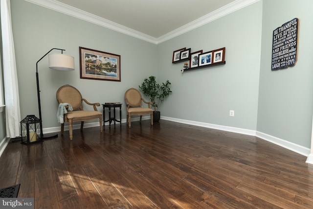 sitting room featuring ornamental molding and dark hardwood / wood-style floors