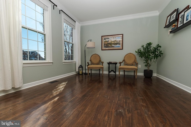 sitting room with crown molding and dark hardwood / wood-style floors