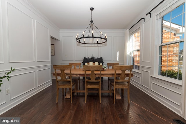 dining room with crown molding, dark hardwood / wood-style floors, and a notable chandelier