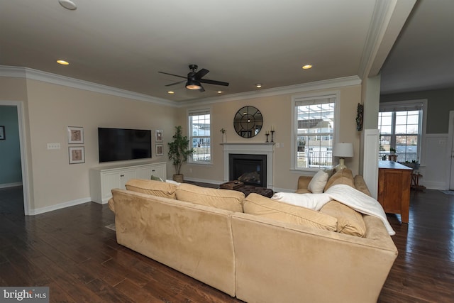 living room featuring ornamental molding, a healthy amount of sunlight, and dark hardwood / wood-style floors