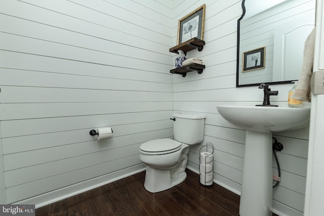 bathroom with wood-type flooring and toilet