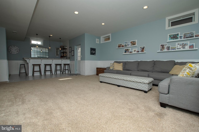 living room with indoor bar and carpet floors