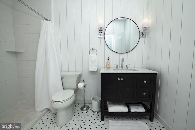 bathroom featuring vanity, tile patterned floors, toilet, and walk in shower