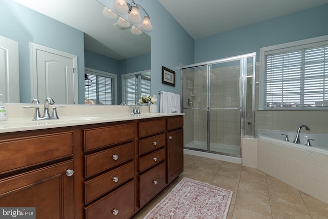 bathroom with vanity, a wealth of natural light, tile patterned floors, and plus walk in shower