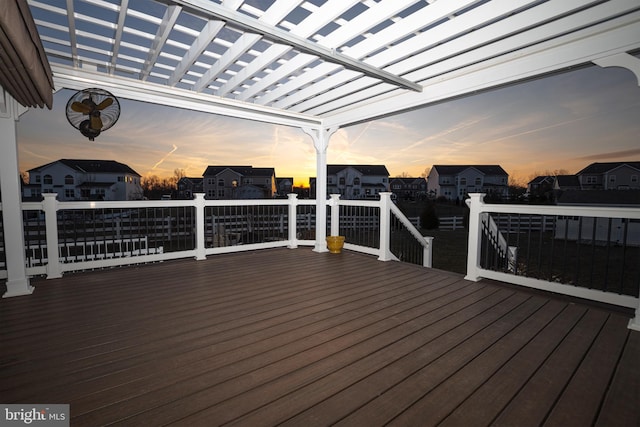 deck at dusk featuring a pergola