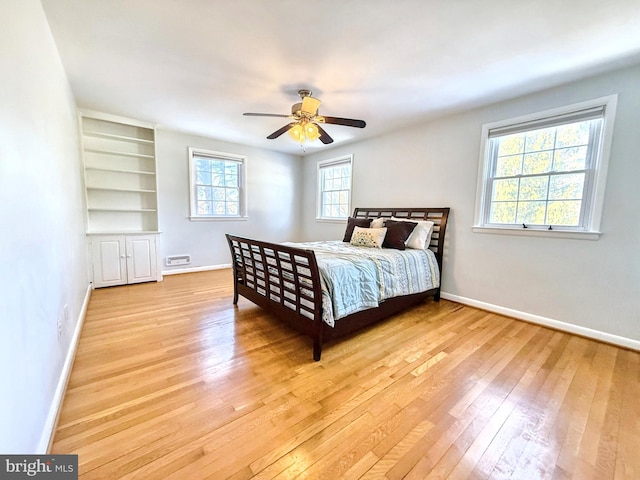 bedroom with ceiling fan and light wood-type flooring