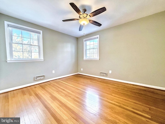 spare room with ceiling fan and light wood-type flooring