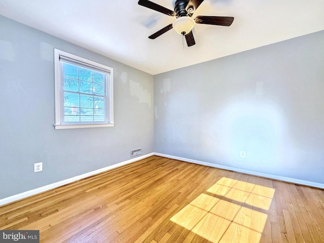 empty room with hardwood / wood-style flooring and ceiling fan