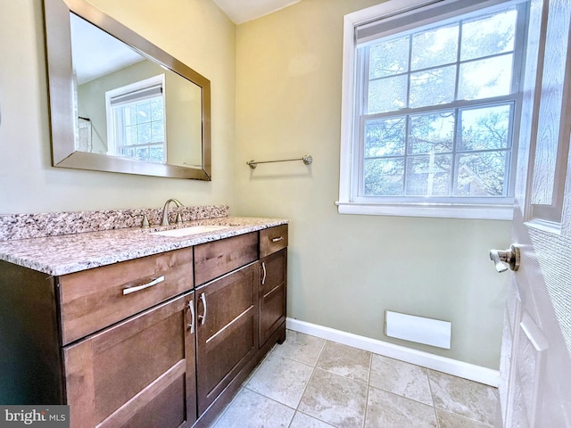 bathroom with tile patterned floors, vanity, and a wealth of natural light